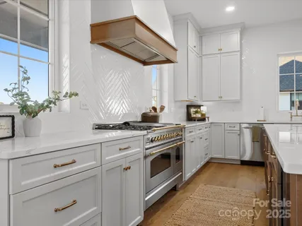 a kitchen with white cabinets and white appliances