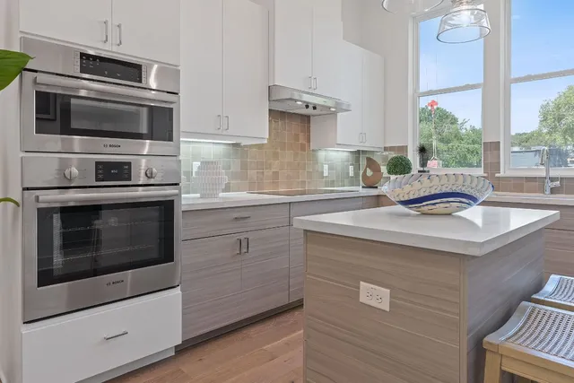 a kitchen with stainless steel appliances a stove sink and microwave