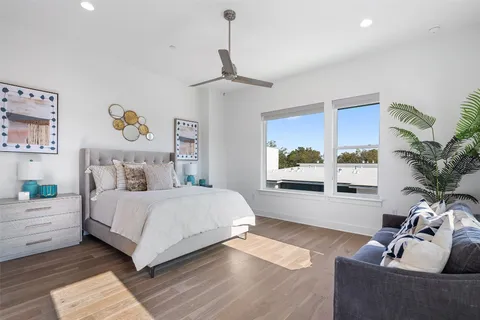 a bedroom with a large bed and a window