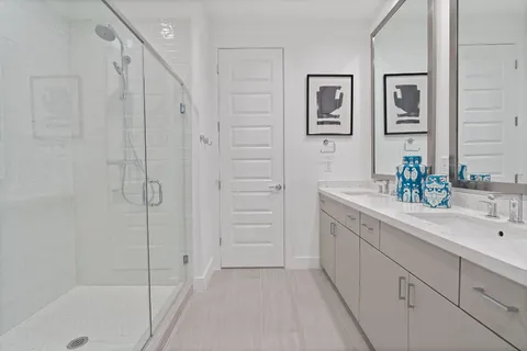 a bathroom with a shower sink and mirror