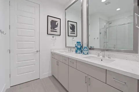 a bathroom with a double vanity sink and a mirror