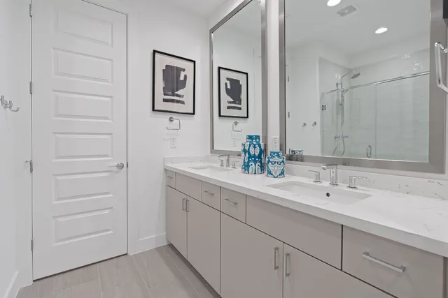a bathroom with a double vanity sink and a mirror