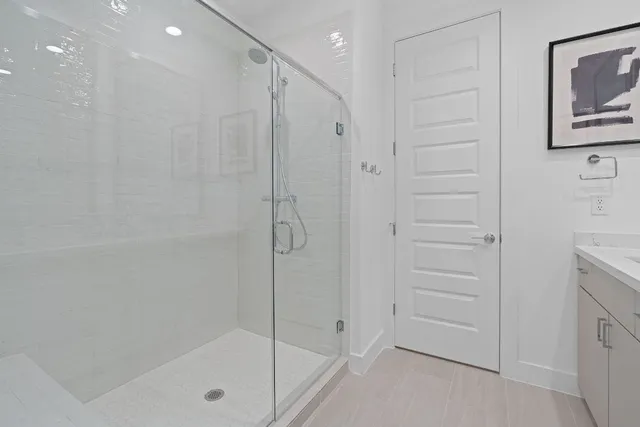 a bathroom with a shower and a glass door