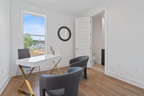 a view of a dining room with furniture window and wooden floor