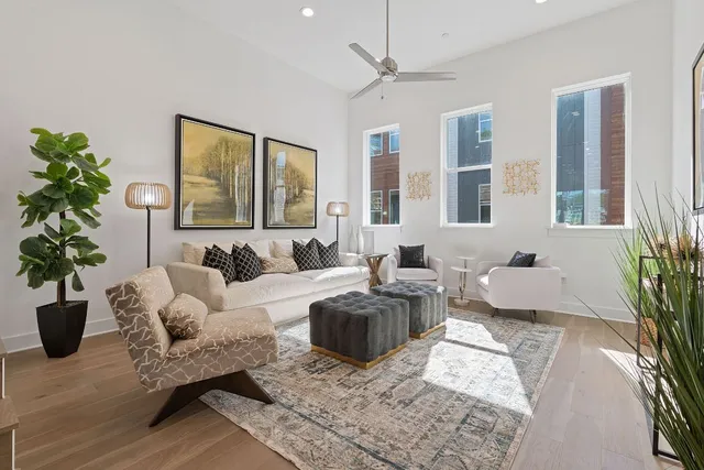 a living room with furniture potted plant and a window