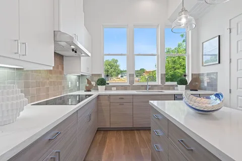 a kitchen with a sink cabinets and window