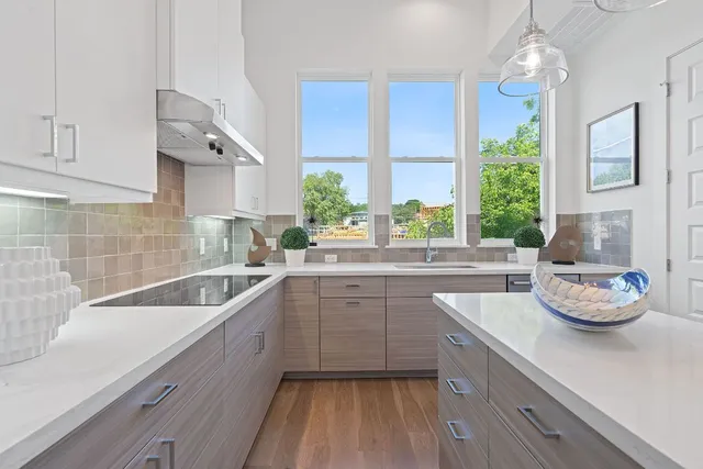 a kitchen with a sink cabinets and window