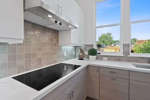 a kitchen with a sink a counter top space and cabinets
