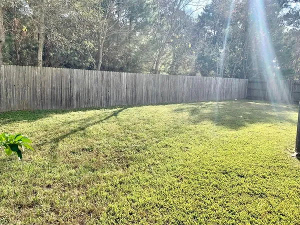 a view of a house with a yard and sitting area