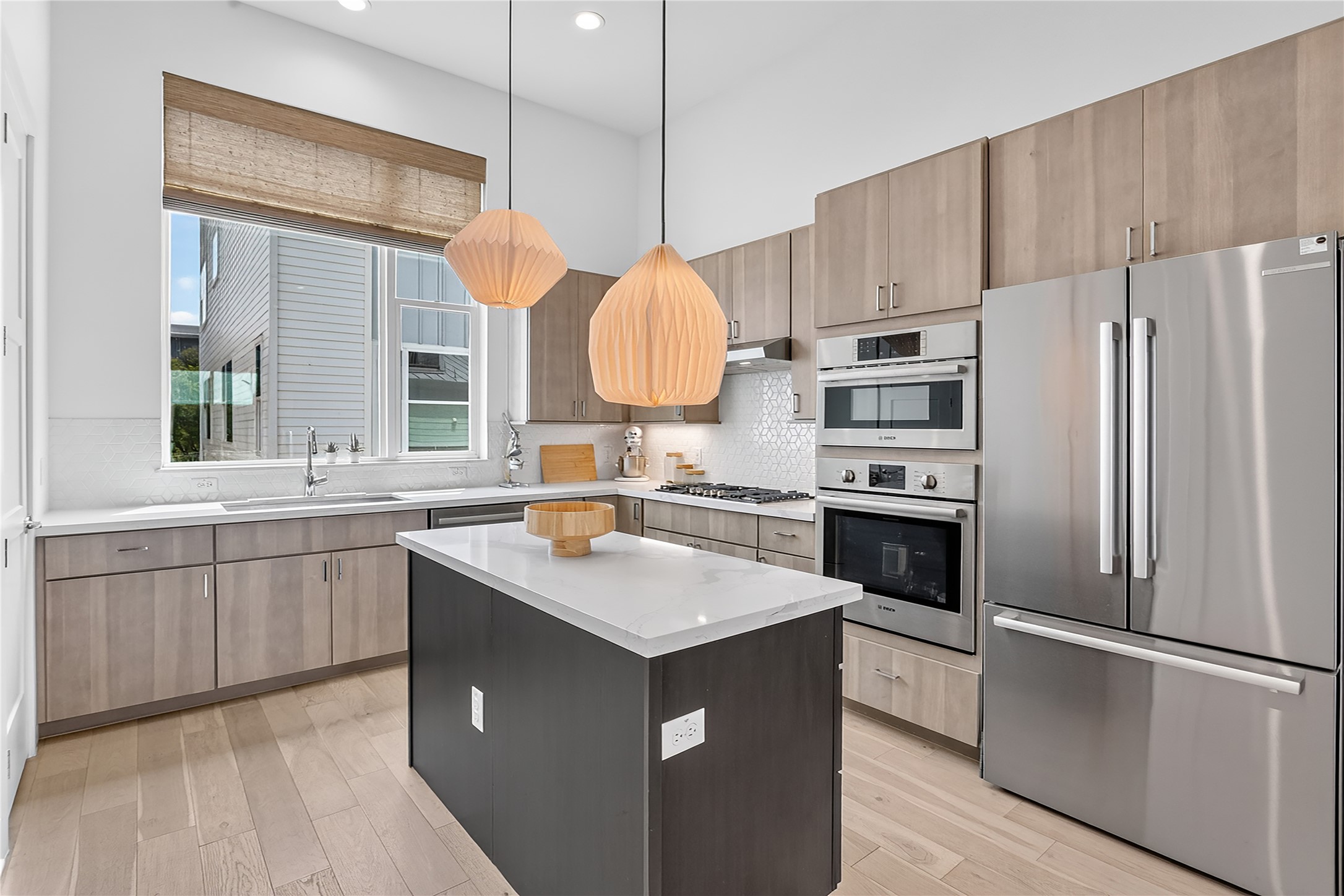 2805 McCurdy Street, Unit 14 Austin, TX 78723 - Photo 3 of 40 A well-lit kitchen with sleek wooden cabinetry and a pristine center island awaits.