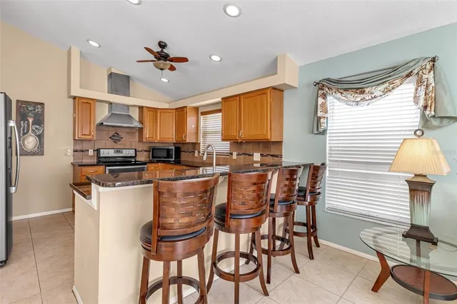 a view of a dining room with furniture and a chandelier