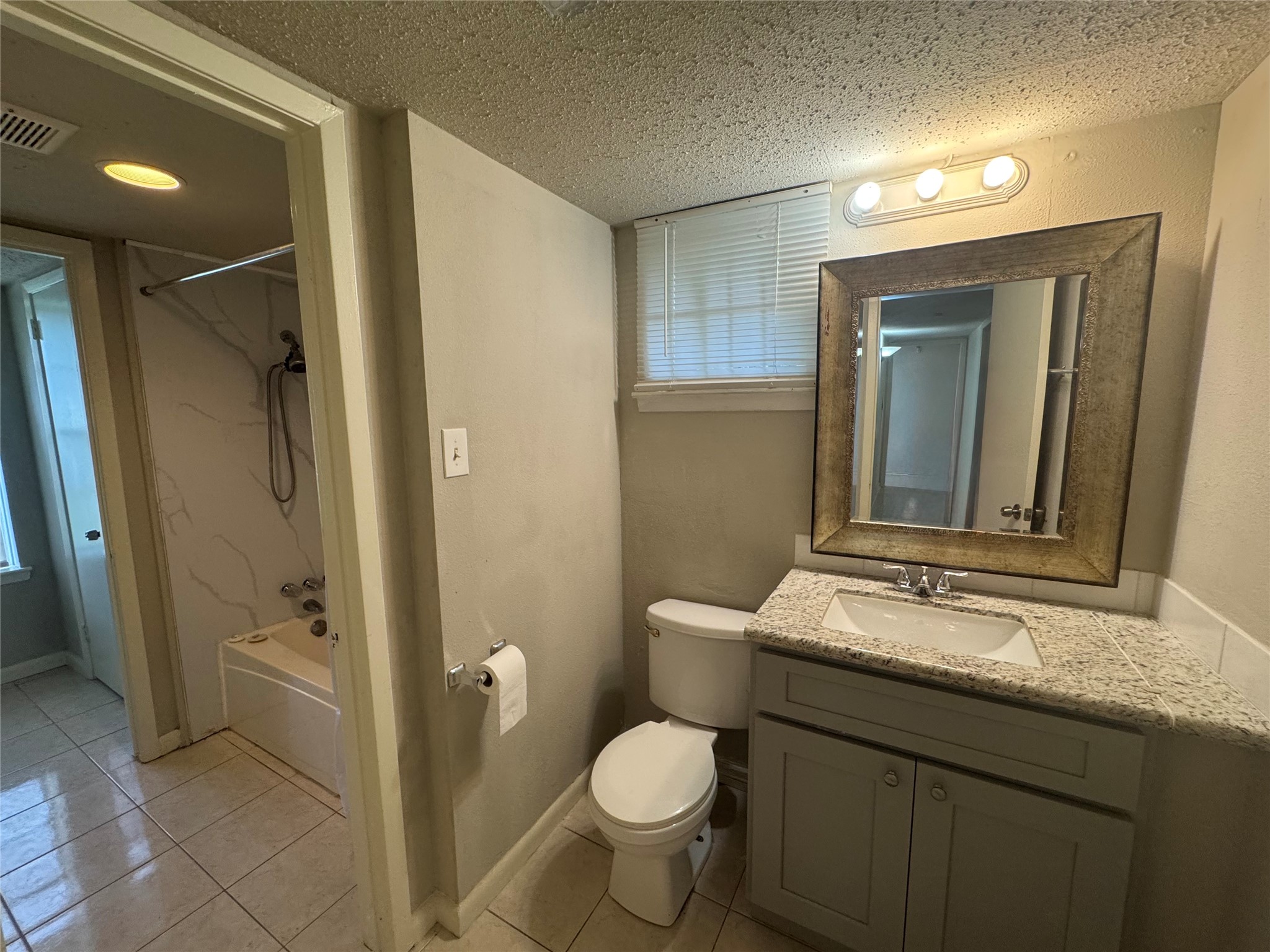 1443 Willow Rock Road Houston, TX 77088 - Photo 21 of 27 a bathroom with a granite countertop sink toilet and shower