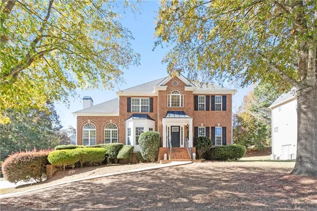 a front view of a house with a yard