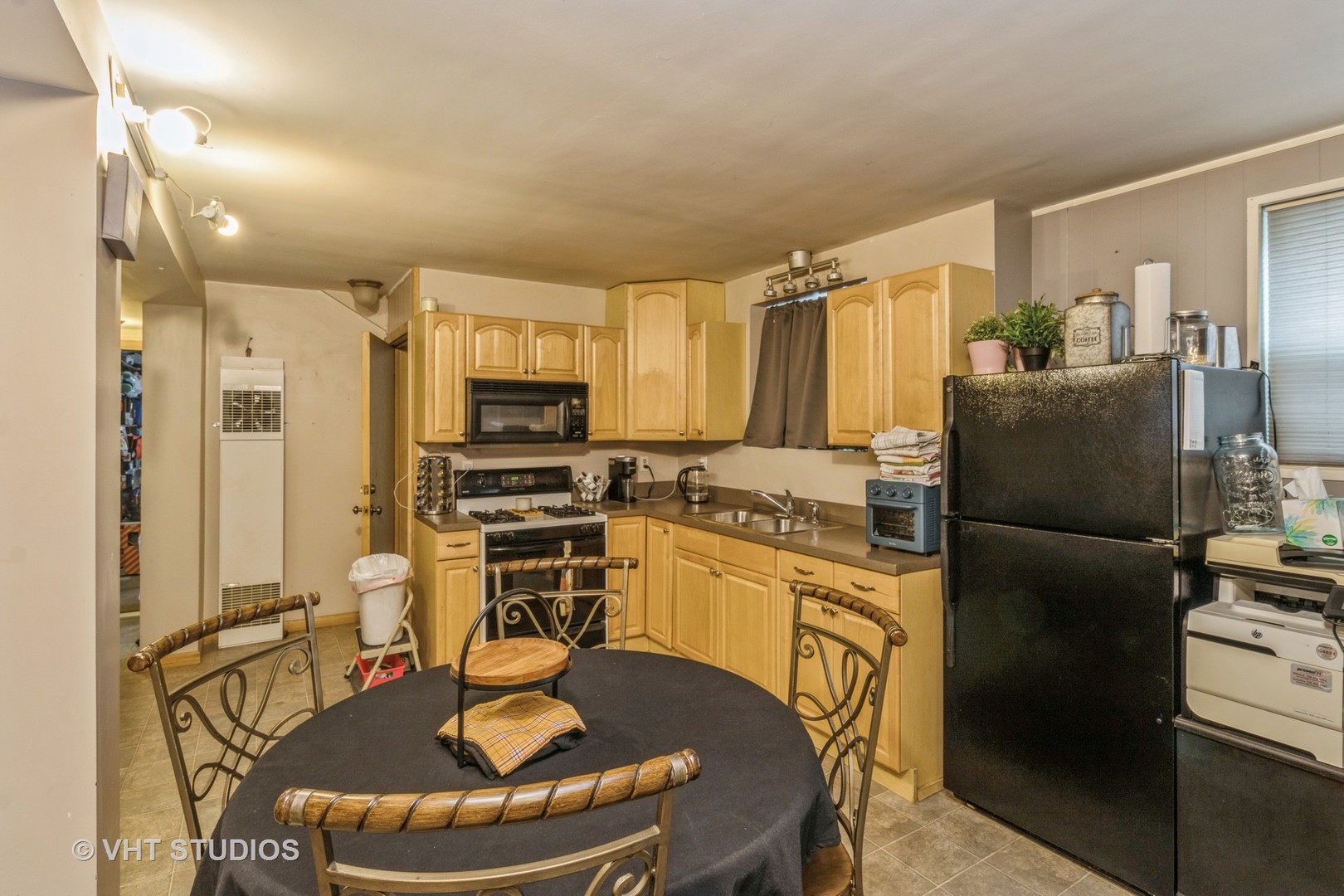 8517 West Foster Avenue Chicago, IL 60656 - Photo 15 of 21 a kitchen with stainless steel appliances granite countertop a refrigerator a stove a sink a dining table and chairs