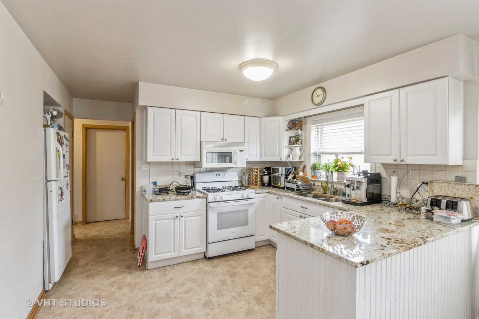 8517 West Foster Avenue Chicago, IL 60656 - Photo 4 of 21 a kitchen with a sink stove top oven and refrigerator