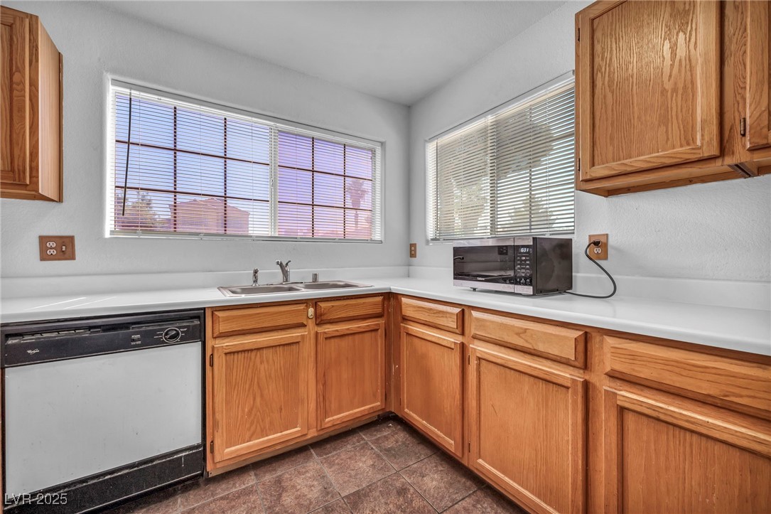 2165 St Paul Way Las Vegas, NV 89104 - Photo 19 of 45 Kitchen with white dishwasher, stainless steel microwave, plenty of natural light, and light countertops