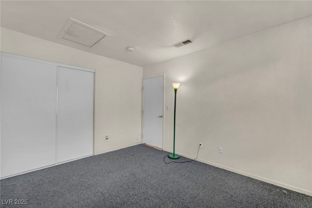 2165 St Paul Way Las Vegas, NV 89104 - Photo 21 of 45 Unfurnished bedroom featuring carpet flooring, attic access, and a closet