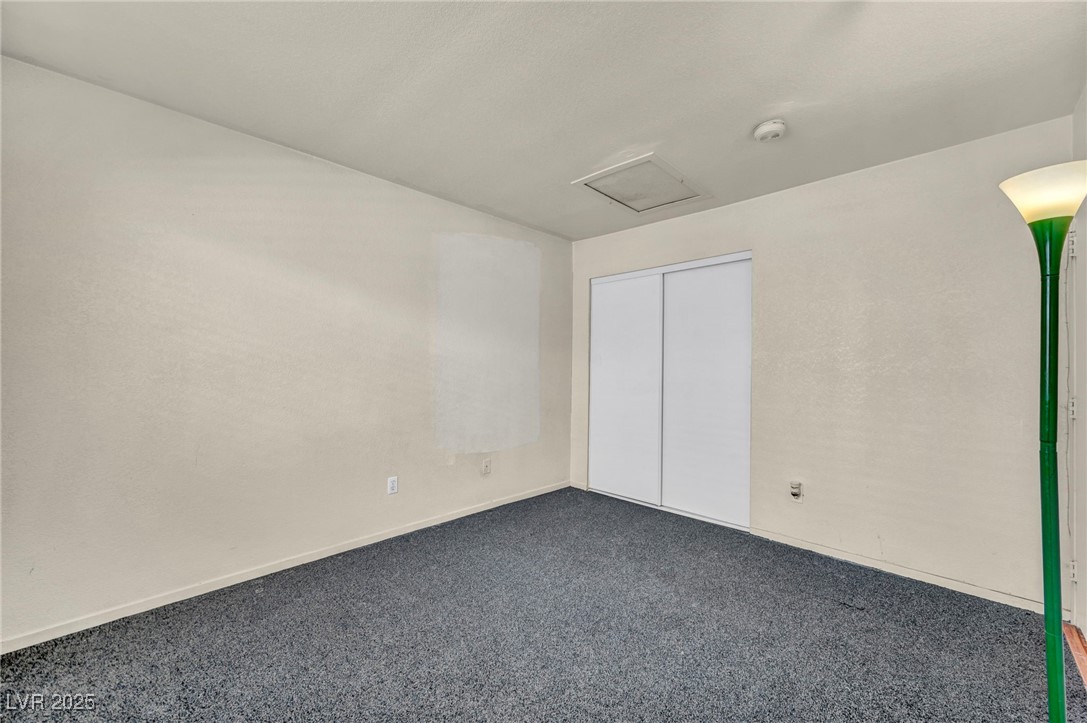 2165 St Paul Way Las Vegas, NV 89104 - Photo 22 of 45 Unfurnished bedroom featuring dark colored carpet, attic access, and a closet