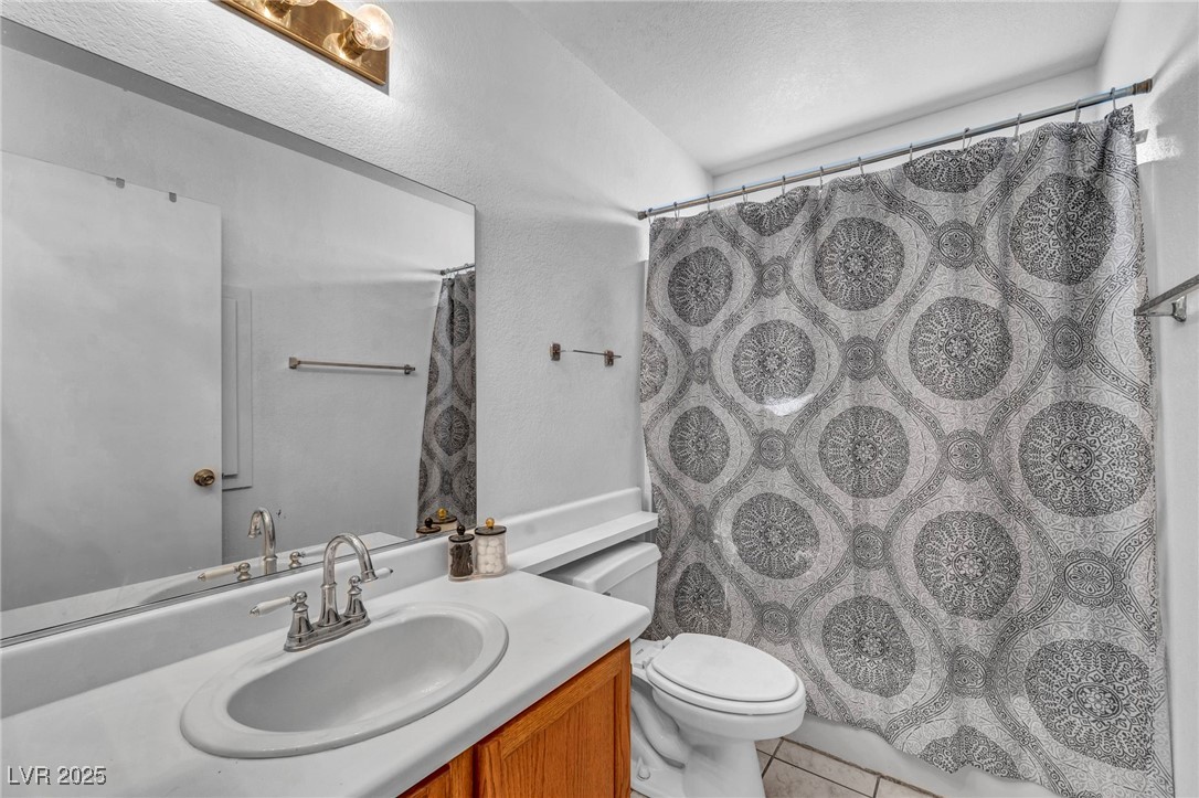 2165 St Paul Way Las Vegas, NV 89104 - Photo 23 of 45 Bathroom featuring vanity, tile patterned flooring, and a shower with curtain