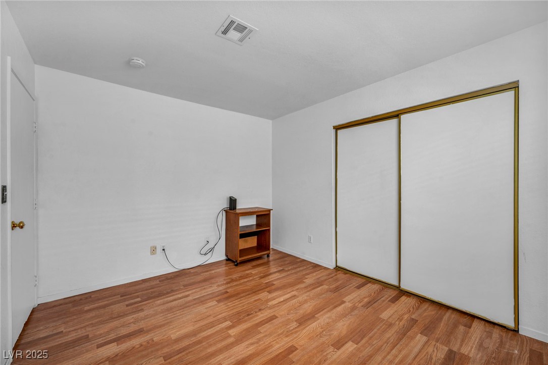 2165 St Paul Way Las Vegas, NV 89104 - Photo 25 of 45 Unfurnished bedroom featuring light wood-style floors and a closet