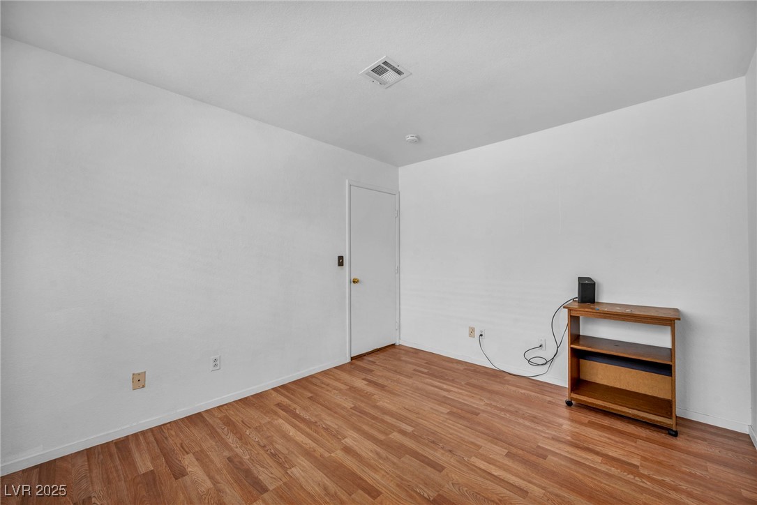 2165 St Paul Way Las Vegas, NV 89104 - Photo 26 of 45 Spare room with wood finished floors and a smoke detector
