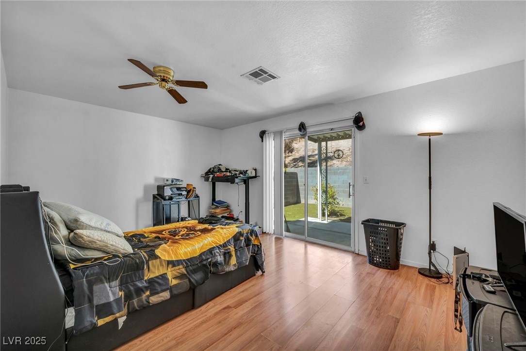 2165 St Paul Way Las Vegas, NV 89104 - Photo 27 of 45 Bedroom featuring access to outside, wood finished floors, and ceiling fan