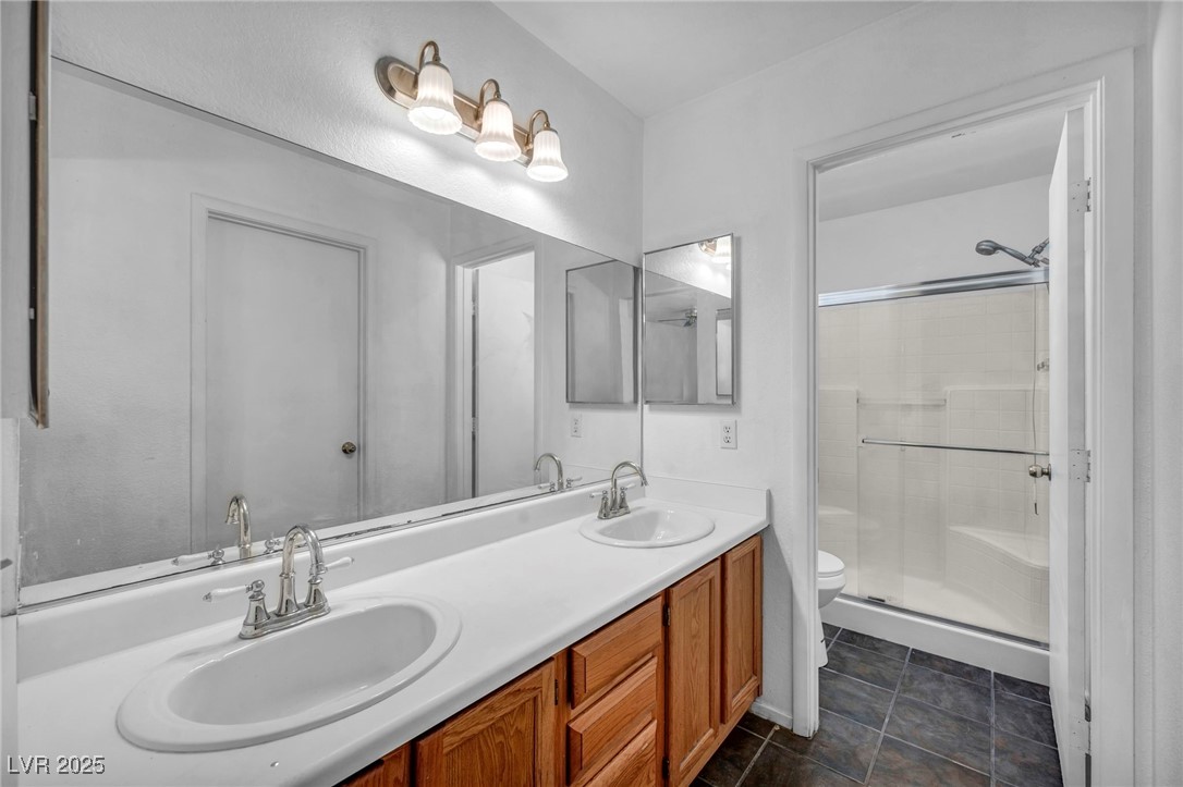 2165 St Paul Way Las Vegas, NV 89104 - Photo 30 of 45 Full bathroom featuring double vanity and a stall shower