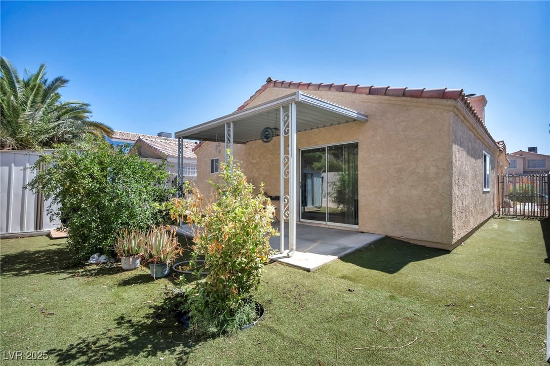 2165 St Paul Way Las Vegas, NV 89104 - Photo 33 of 45 Back of house featuring stucco siding and a tiled roof
