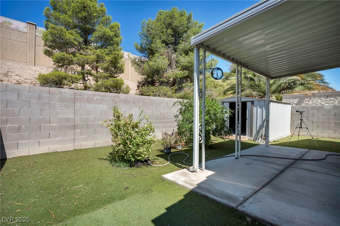 2165 St Paul Way Las Vegas, NV 89104 - Photo 34 of 45 Fenced backyard featuring a shed and a patio area