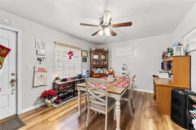 a view of a dining room with furniture wooden floor and a chandelier