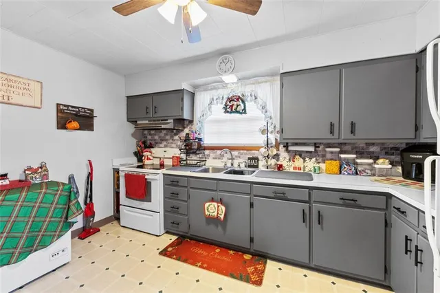 a kitchen with stainless steel appliances granite countertop a sink stove and cabinets