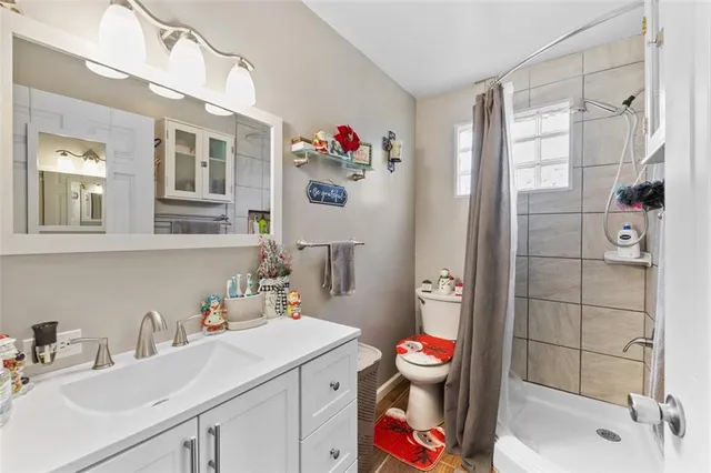 a bathroom with a sink mirror vanity and toilet