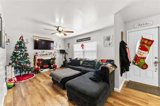 a living room with furniture a flat screen tv and a fireplace