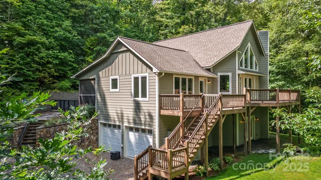 a view of a house with wooden deck front of house