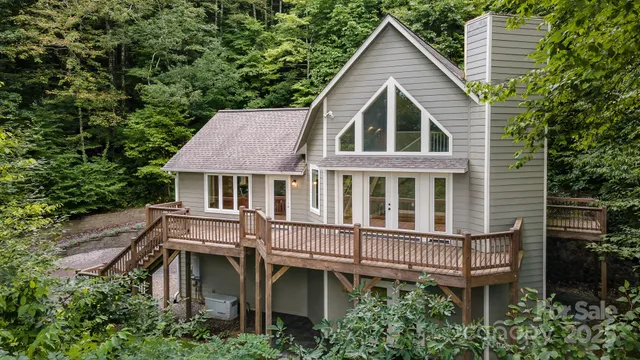 a view of a house with a yard and sitting area