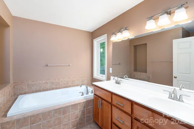 a bathroom with a shower sink and mirror