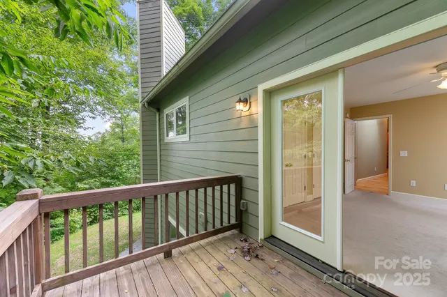 a view of balcony with wooden floor and fence