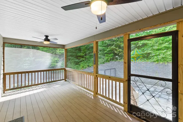 a view of a hallway with wooden floor and a glass door