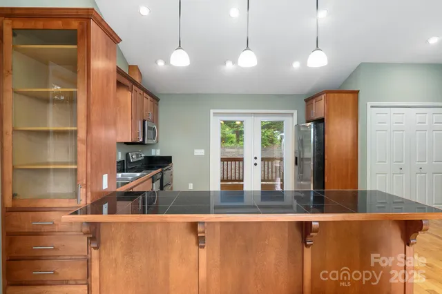 a view of kitchen with window and cabinets