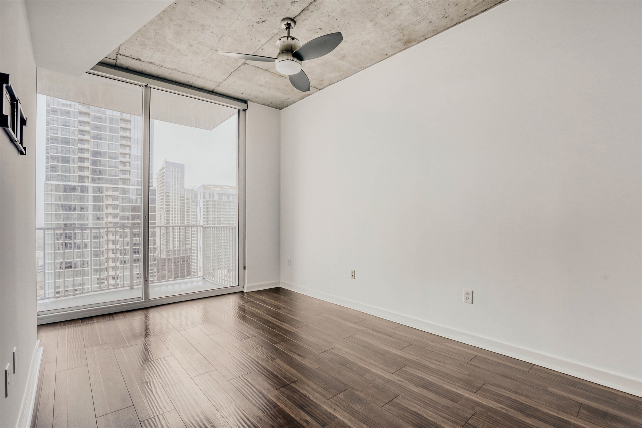 360 Nueces Street, Unit 2004 Austin, TX 78701 - Photo 22 of 34 a view of room with wooden floor and fan