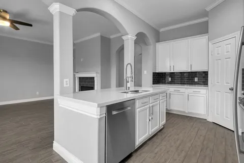 a kitchen with white cabinets and white appliances