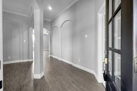 a view of a hallway with wooden floor and closet