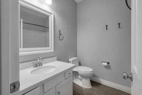 a bathroom with a sink toilet and a mirror