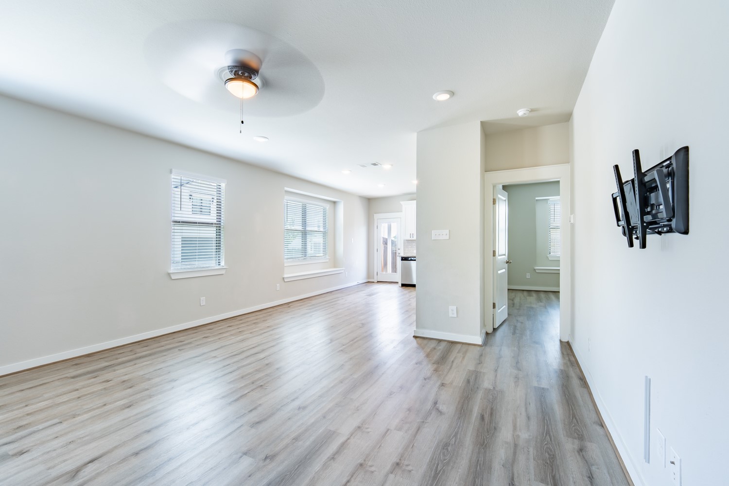 147 Waterside Road, Unit A Buda, TX 78610 - Photo 10 of 27 A generously proportioned living space with wide plank flooring and abundant natural light.