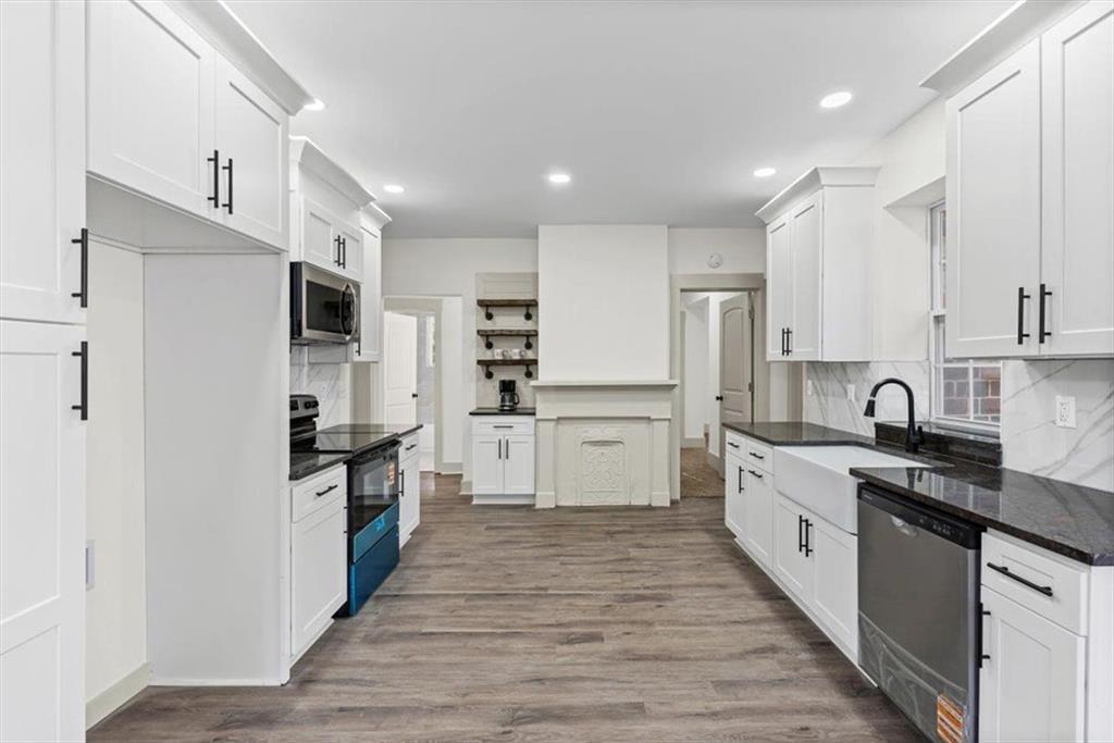 203 Church Street Northeast Rome, GA 30161 - Photo 13 of 36 a large kitchen with stainless steel appliances and white cabinets