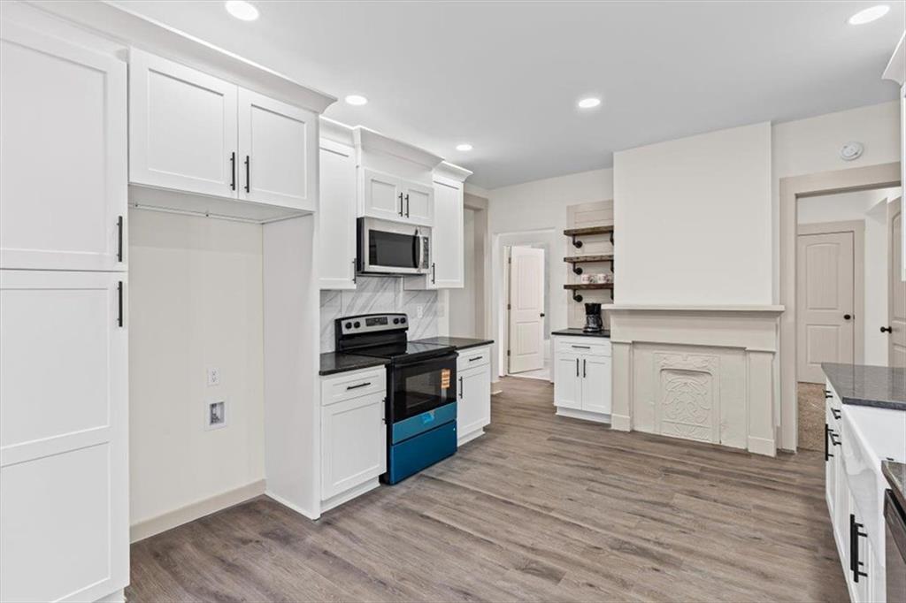 203 Church Street Northeast Rome, GA 30161 - Photo 14 of 36 a kitchen with a refrigerator stove and white cabinets