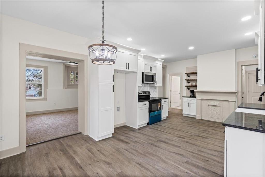 203 Church Street Northeast Rome, GA 30161 - Photo 16 of 36 a view of a kitchen with refrigerator and wooden floor