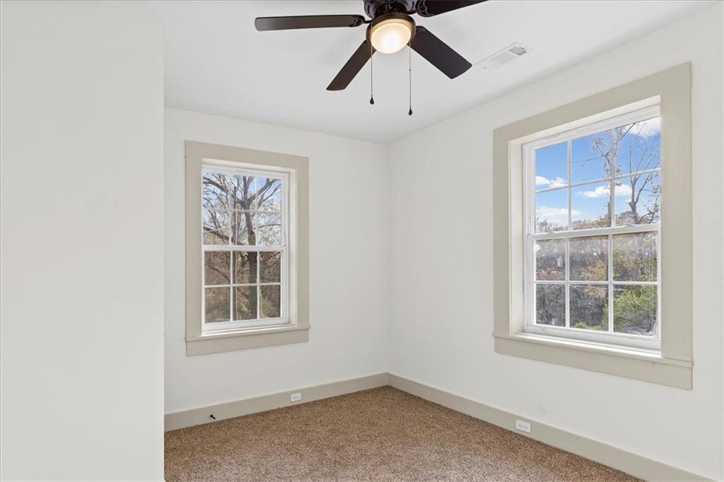 203 Church Street Northeast Rome, GA 30161 - Photo 23 of 36 an empty room with a window and ceiling fan