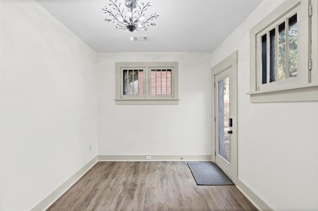 203 Church Street Northeast Rome, GA 30161 - Photo 24 of 36 an empty room with wooden floor and windows