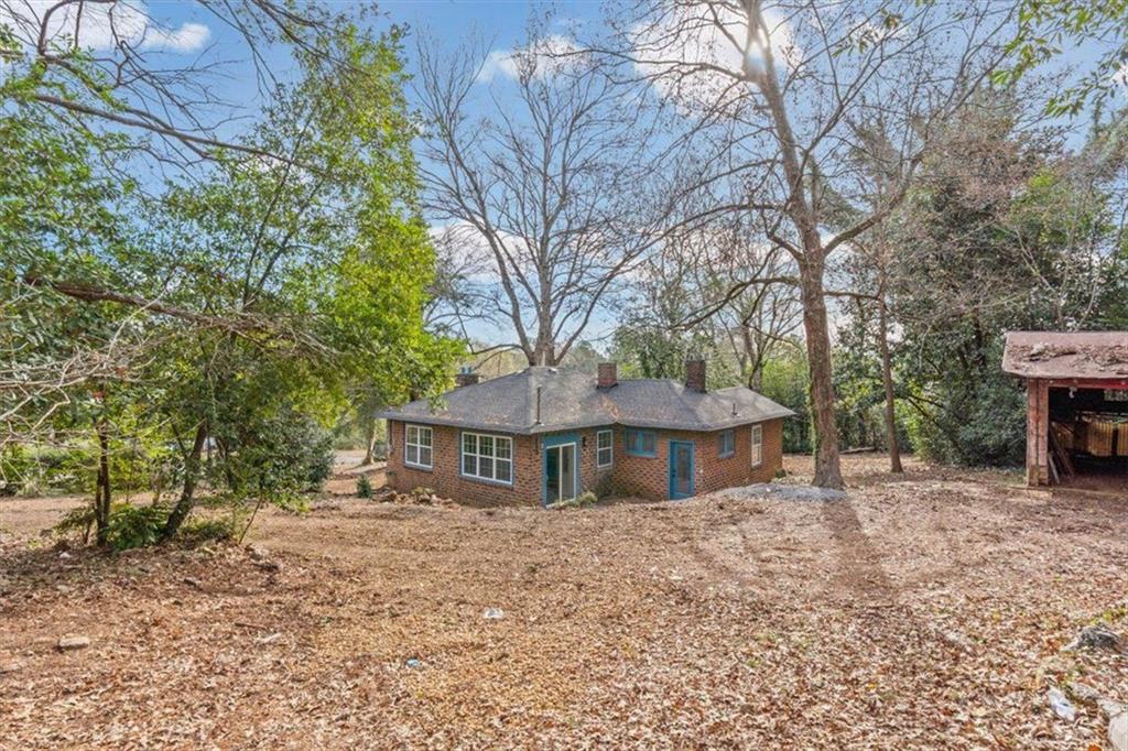 203 Church Street Northeast Rome, GA 30161 - Photo 26 of 36 a front view of a house with a yard and large tree